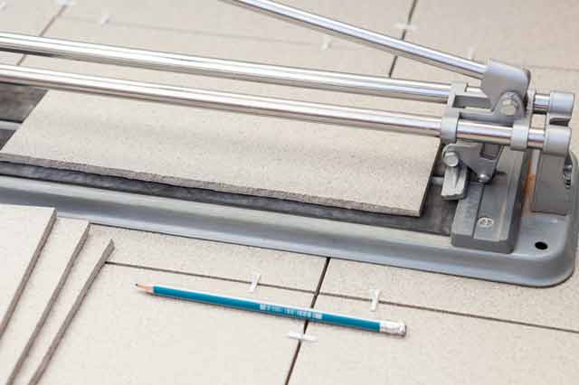 precision tool for cutting tile with a pencil on side.