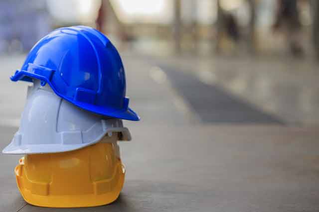 three safety construction helmet stacked on top of each other.