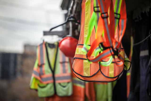 reflective vests hanged on a construction site.