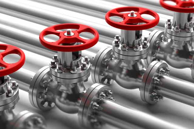 red valves on silver shiny pipes that help in controlling the water flow.