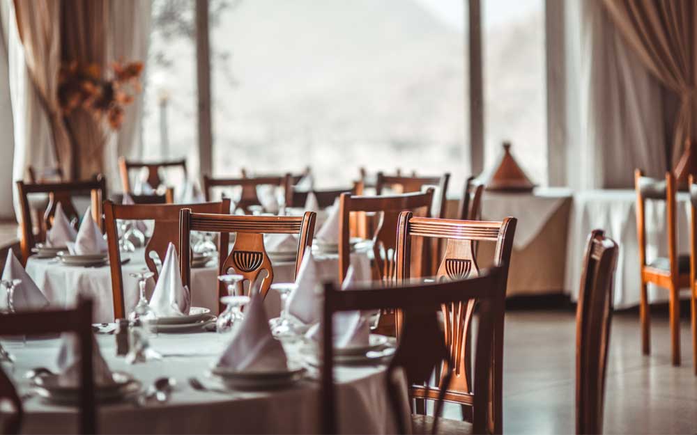 tables that are ready with the food and beverage mise en place to accommodate guests